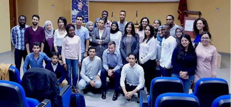 Jack Turman posing with students while in Morocco